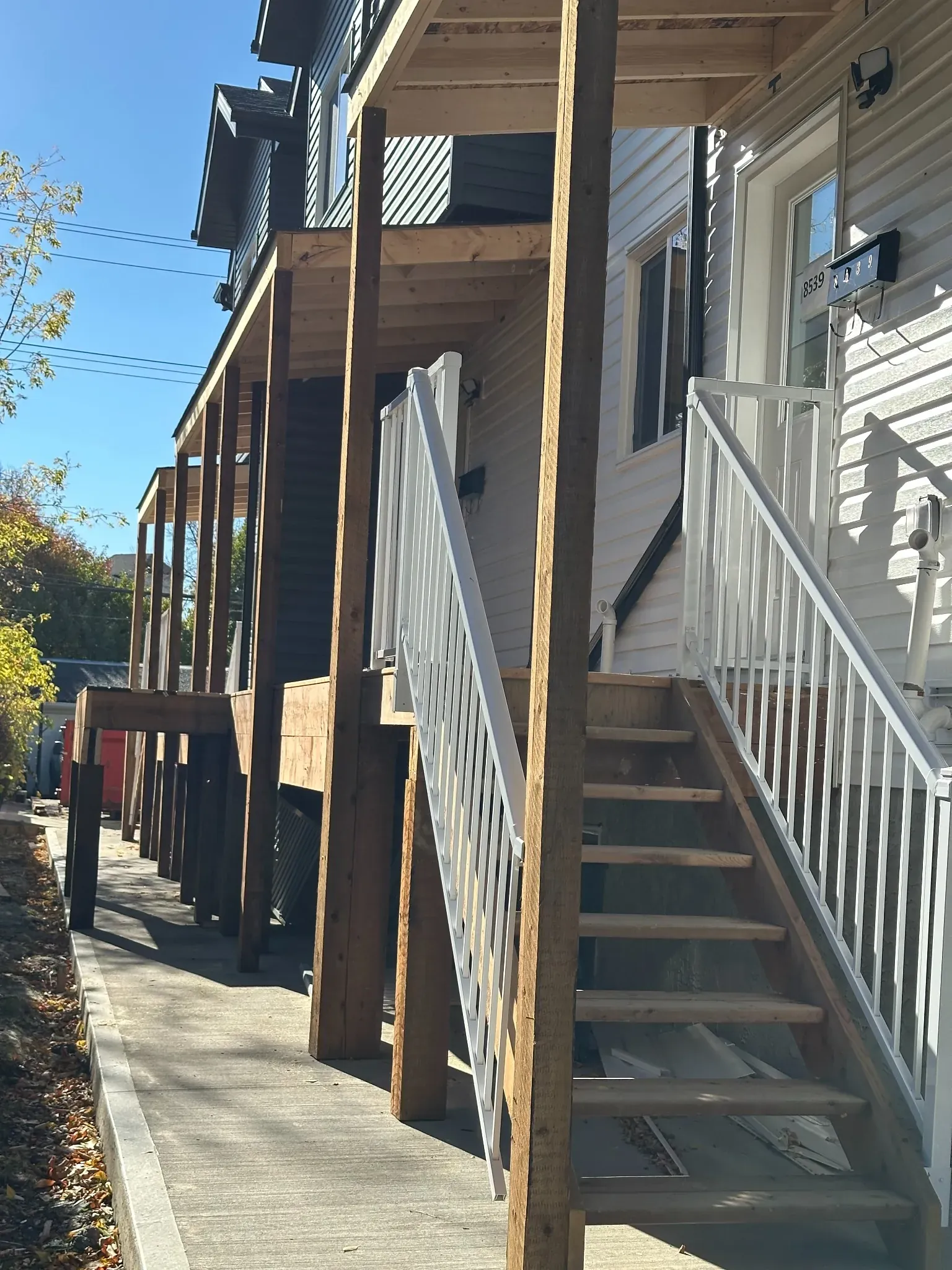 Deck with stairs, railing, and covered roof